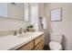 Bathroom featuring neutral tones, a single sink vanity with stone countertop, and a toilet at 5511 S Lowell Blvd, Littleton, CO 80123