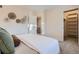 Bright bedroom featuring wall decor, carpet, and an open closet at 5511 S Lowell Blvd, Littleton, CO 80123