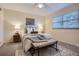 Bedroom featuring neutral tones, carpet, ceiling fan and a large window with blinds at 5511 S Lowell Blvd, Littleton, CO 80123