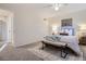 Bedroom featuring neutral tones, carpet, ceiling fan and a bench at the foot of the bed at 5511 S Lowell Blvd, Littleton, CO 80123