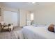 Bright bedroom showcasing a large closet, and a cozy chair with throw blanket at 5511 S Lowell Blvd, Littleton, CO 80123