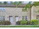 Charming townhome featuring a brick facade, well-manicured lawn, and lush landscaping at 5511 S Lowell Blvd, Littleton, CO 80123