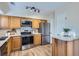 Well-equipped kitchen with stainless steel appliances, wood cabinets, and ample counter space at 5511 S Lowell Blvd, Littleton, CO 80123