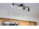Track lighting illuminates the kitchen cabinets and stainless steel microwave at 5511 S Lowell Blvd, Littleton, CO 80123