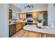 Modern kitchen featuring wood cabinets, stainless steel appliances, and functional layout at 5511 S Lowell Blvd, Littleton, CO 80123
