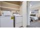 A convenient laundry room with a washer and dryer is situated next to the bedroom at 5511 S Lowell Blvd, Littleton, CO 80123