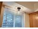 A decorative light fixture is mounted above the window with wood trim at 5511 S Lowell Blvd, Littleton, CO 80123