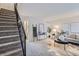 Bright living room with carpet, stylish decor, and easy access to the staircase at 5511 S Lowell Blvd, Littleton, CO 80123