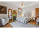 Bedroom with charming fireplace, plush chair, and natural wood trim at 1345 N Franklin St, Denver, CO 80218