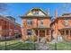 Charming two-story brick home featuring a quaint front porch and well-maintained landscaping at 1345 N Franklin St, Denver, CO 80218