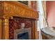 Close-up on an ornate fireplace with tiled surround and carved wooden mantel at 1345 N Franklin St, Denver, CO 80218