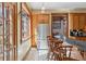 Eat-in kitchen with stainless steel refrigerator, classic cabinetry, and a black and white checkerboard floor at 1345 N Franklin St, Denver, CO 80218