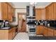 Well-lit kitchen features a stainless steel range and classic cabinetry with black countertops and decorative tile accents at 1345 N Franklin St, Denver, CO 80218