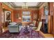 Cozy living room with a fireplace, leaded glass windows, period details, and warm, inviting colors at 1345 N Franklin St, Denver, CO 80218