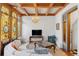 Bright living room with stained glass window, crystal chandelier, coffered ceiling, and decorative fireplace at 1345 N Franklin St, Denver, CO 80218