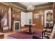 An opulent living room with rich woodwork, a fireplace, hardwood floors, and sophisticated decor at 1345 N Franklin St, Denver, CO 80218
