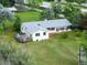 Aerial view of a home with a deck and patio offers outdoor living with large lawn at 7313 S Boulder Rd, Boulder, CO 80303