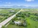Incredible aerial view of neighborhood surrounded by rolling hills, trees, and a tranquil mountain backdrop at 7313 S Boulder Rd, Boulder, CO 80303