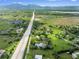 Breathtaking aerial view of homes surrounded by lush greenery, mountains, and a serene lake at 7313 S Boulder Rd, Boulder, CO 80303