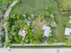 Aerial view of a property with lush greenery, mature trees, and multiple structures at 7313 S Boulder Rd, Boulder, CO 80303