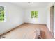 Sunlit bedroom offers dual windows and a doorway with a view of the outdoors at 7313 S Boulder Rd, Boulder, CO 80303