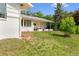 Charming home with a covered porch, lush green lawn, and mature trees at 7313 S Boulder Rd, Boulder, CO 80303