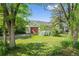 Charming ranch-style home with mature trees and a well-maintained lawn and an oversized garage door at 7313 S Boulder Rd, Boulder, CO 80303