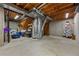 Unfinished basement with concrete floor, exposed ceiling, shelving, and ample storage space at 14822 E Penwood Pl # D, Aurora, CO 80015