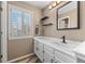 Bathroom featuring single sink vanity, storage and window with wooden shutters at 14822 E Penwood Pl # D, Aurora, CO 80015