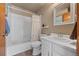 Bright bathroom featuring a white tiled shower-tub combo, white vanity, and neutral wall color at 14822 E Penwood Pl # D, Aurora, CO 80015