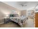 Bedroom featuring a ceiling fan and a queen bed with two side tables and lamps at 14822 E Penwood Pl # D, Aurora, CO 80015