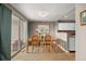 Bright dining area with sliding glass door and view into the kitchen and access to the back patio at 14822 E Penwood Pl # D, Aurora, CO 80015