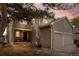 Charming two-story home featuring a two-car garage and a welcoming front porch at sunset at 14822 E Penwood Pl # D, Aurora, CO 80015