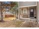 Cozy front porch with a bench, complemented by a well-maintained lawn and mature trees at 14822 E Penwood Pl # D, Aurora, CO 80015