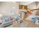 Comfortable living room featuring a staircase, neutral tones, and stylish furnishings at 14822 E Penwood Pl # D, Aurora, CO 80015