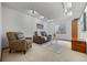 Cozy living room with neutral carpet, sofa, arm chair, area rug, and window at 14822 E Penwood Pl # D, Aurora, CO 80015