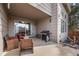 Relaxing covered patio with wicker chairs, a barbecue grill, and exterior lighting at 14822 E Penwood Pl # D, Aurora, CO 80015