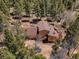 Aerial view of home and property showcasing roof, yard, and mature trees at 10852 Conifer Mountain Rd, Conifer, CO 80433