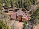Aerial view of home and property showcasing roof, deck and mature trees at 10852 Conifer Mountain Rd, Conifer, CO 80433