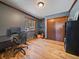 Bedroom featuring hardwood floors, a window overlooking the treeline and a closet at 10852 Conifer Mountain Rd, Conifer, CO 80433