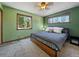 Bedroom with carpet and green walls, two windows to view the treeline, and a wooden bed frame at 10852 Conifer Mountain Rd, Conifer, CO 80433