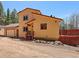 Exterior view of the two-story home, showcasing the attached garage, siding, and front entryway at 10852 Conifer Mountain Rd, Conifer, CO 80433