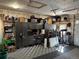 View of the spacious garage featuring checkered flooring, overhead lighting and cabinet storage at 10852 Conifer Mountain Rd, Conifer, CO 80433