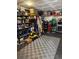 View of the spacious garage featuring checkered flooring and ample storage at 10852 Conifer Mountain Rd, Conifer, CO 80433