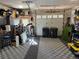 Spacious garage with a door, checkered flooring, storage and a garage door at 10852 Conifer Mountain Rd, Conifer, CO 80433