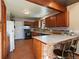 Cozy kitchen with wood cabinets, stainless steel appliances, and tile countertops at 10852 Conifer Mountain Rd, Conifer, CO 80433