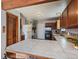View of the kitchen featuring tile countertops and wood cabinets and floors at 10852 Conifer Mountain Rd, Conifer, CO 80433