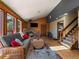 Living room with wood paneling, wood burning stove, and cozy seating area at 10852 Conifer Mountain Rd, Conifer, CO 80433