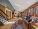 Bright living room featuring wood floors, a skylight, and views of the surrounding forest at 10852 Conifer Mountain Rd, Conifer, CO 80433
