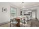 Light filled dining room features modern lighting and overlooks the well-appointed kitchen at 2705 N Lafayette St, Denver, CO 80205